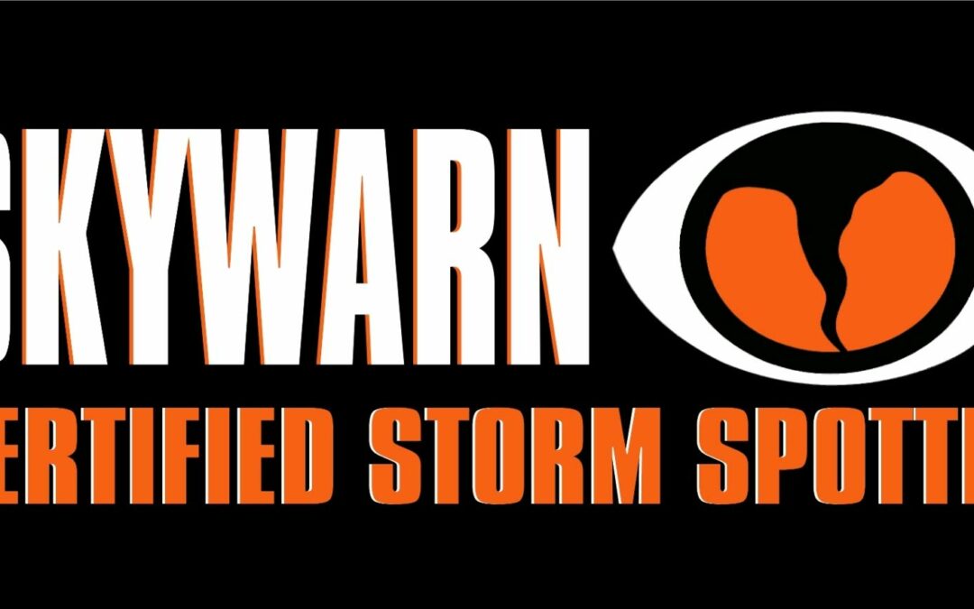 A rectangular black badge with the white text "SKYWARN" in bold on the left. On the right, there is the SKYWARN logo, an eye-like shape with an orange center and black tornado design. Below, in bold orange text, it reads "CERTIFIED STORM SPOTTER" - proudly protecting Flagler County and Palm Coast residents.