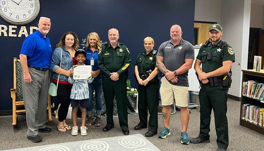 Sheriff Staly Presents Elementary School Student with Scholarship for Alerting of Possible Abduction