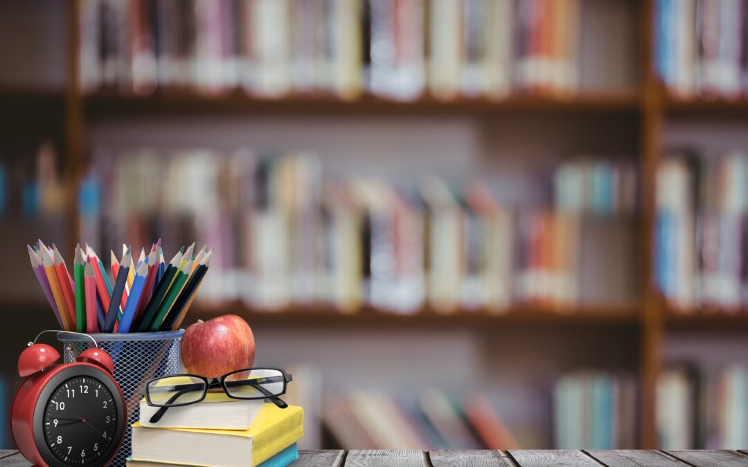 digital composite of School materials and apple with library background