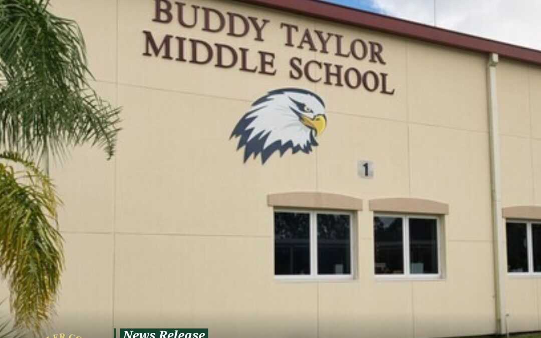 The exterior of Buddy Taylor Middle School with a large eagle logo is shown A news release at the bottom states, “ Year Old Arrested Following Shooting Threat Made to Buddy Taylor Middle School,” accompanied by the Flagler County Sheriff's Office emblem